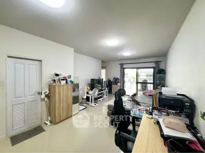 Spacious living room with modern decor and ample natural light