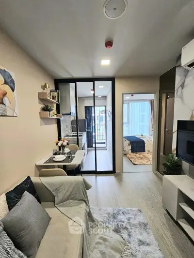 Modern apartment interior with open layout connecting living room, dining area, and bedroom.