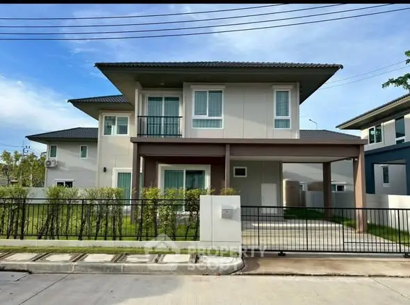 Modern two-story house with a sleek design, spacious driveway, and well-maintained front yard in a suburban neighborhood.