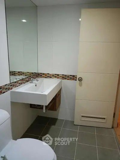 Modern bathroom with sleek sink and stylish tile accents