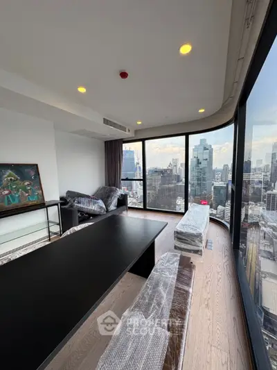 Stunning high-rise living room with panoramic city views and modern furnishings.