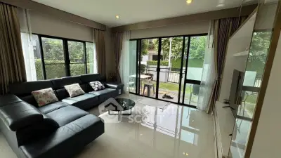Spacious living room with large windows and modern decor in a luxurious home.