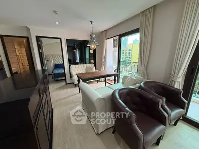 Spacious living room with elegant furniture and city view balcony, perfect for modern urban living.