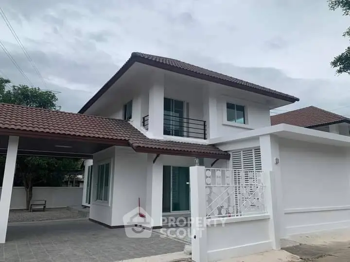 Charming two-story house with tiled roof and modern design in a serene neighborhood.