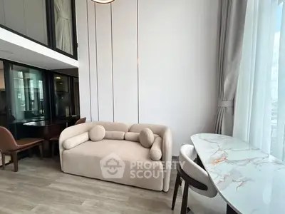 Modern living room with stylish beige sofa and elegant marble dining table
