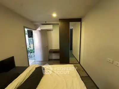 Modern bedroom with sleek design and mirrored wardrobe in a cozy apartment.