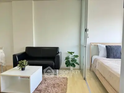 Modern studio apartment with cozy living area and stylish bedroom