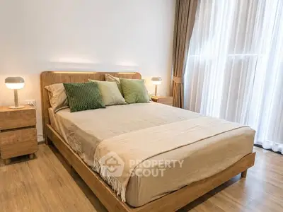 Modern bedroom with wooden furniture and large window with curtains, creating a cozy and inviting atmosphere.