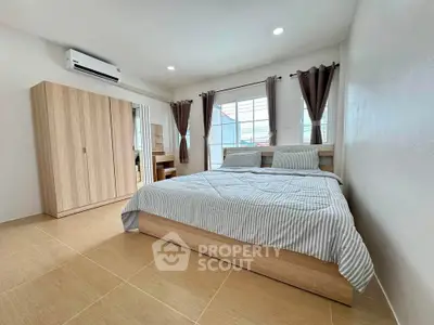 Spacious bedroom with modern furnishings and natural light