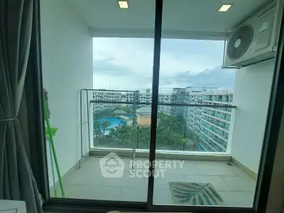 Modern apartment balcony with pool view and air conditioning unit, perfect for relaxation.