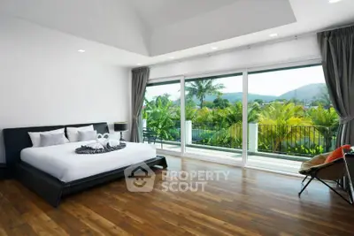 Luxurious bedroom with large windows and stunning tropical view