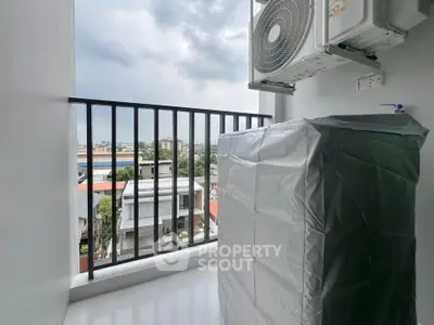 Modern balcony with city view and air conditioning unit, perfect for urban living.