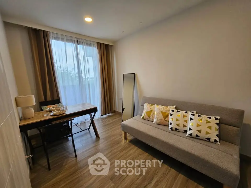 Modern living room with stylish sofa and dining area, featuring elegant decor and natural light.