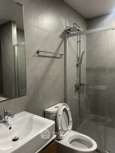 Modern bathroom with sleek shower and contemporary fixtures in a stylish apartment.