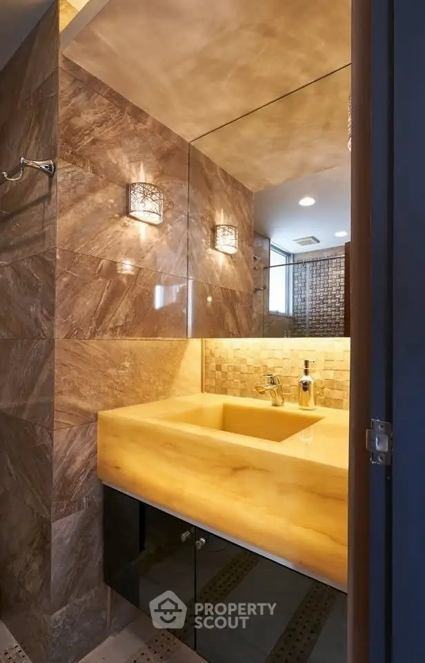 Luxurious bathroom with elegant stone tiles and modern lighting
