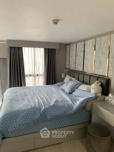 Cozy bedroom with stylish decor and large window for natural light