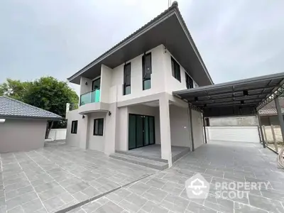 Modern two-story house with spacious driveway and sleek design