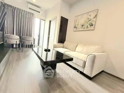 Modern living room with sleek furniture and balcony access