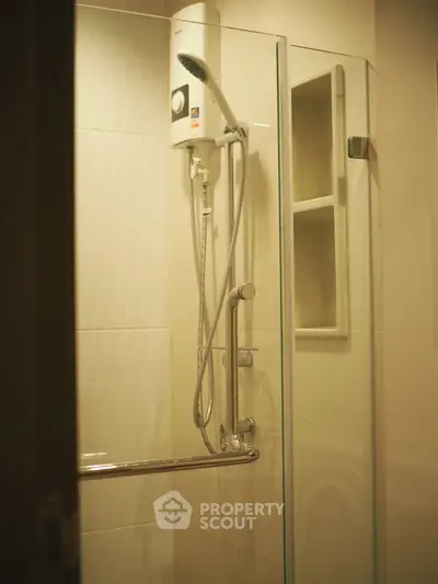 Modern bathroom with glass shower enclosure and sleek fixtures