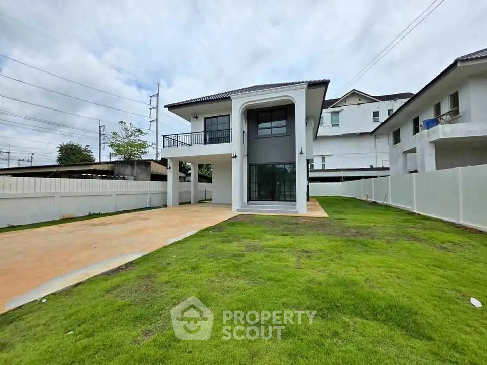 Modern two-story house with spacious driveway and lush green lawn
