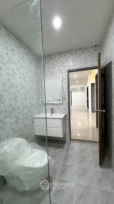 Modern bathroom with sleek fixtures and stylish tile design in a contemporary home.