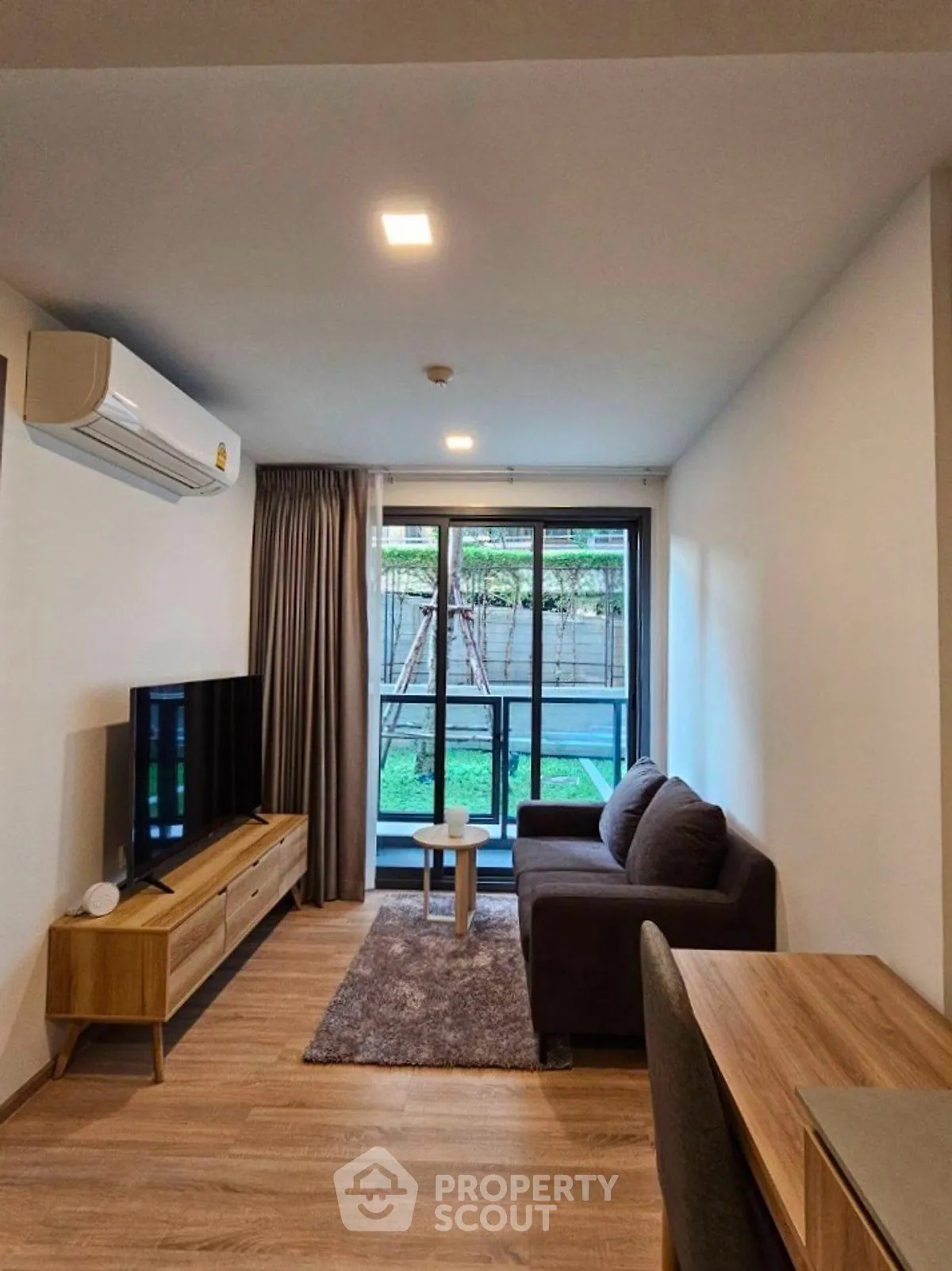 Modern living room with garden view and cozy furniture