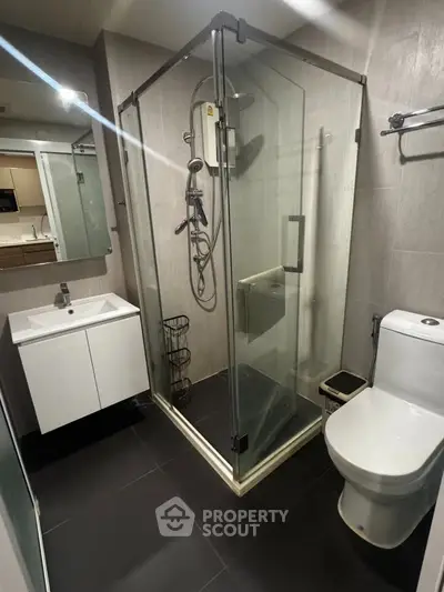 Modern bathroom with glass shower enclosure and sleek fixtures