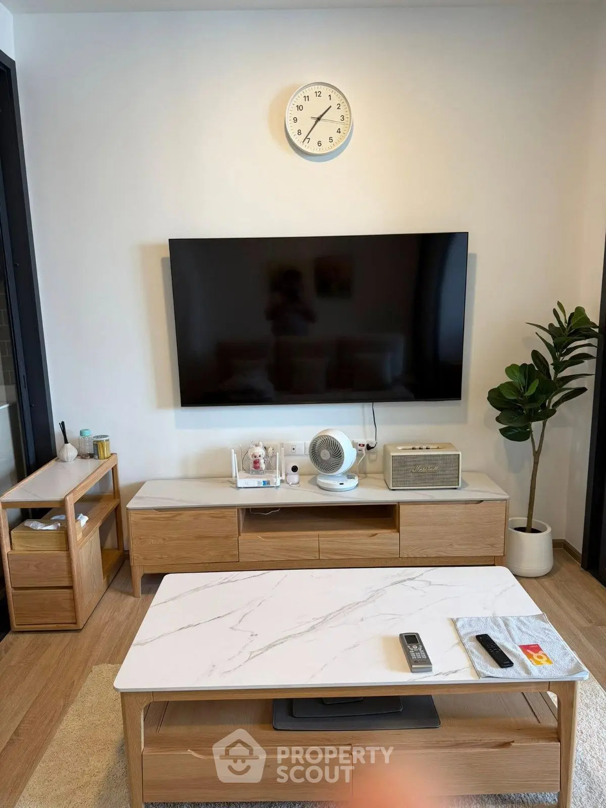 Modern living room with sleek TV setup and stylish wooden furniture