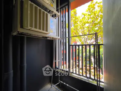 Compact balcony with air conditioning unit and garden view