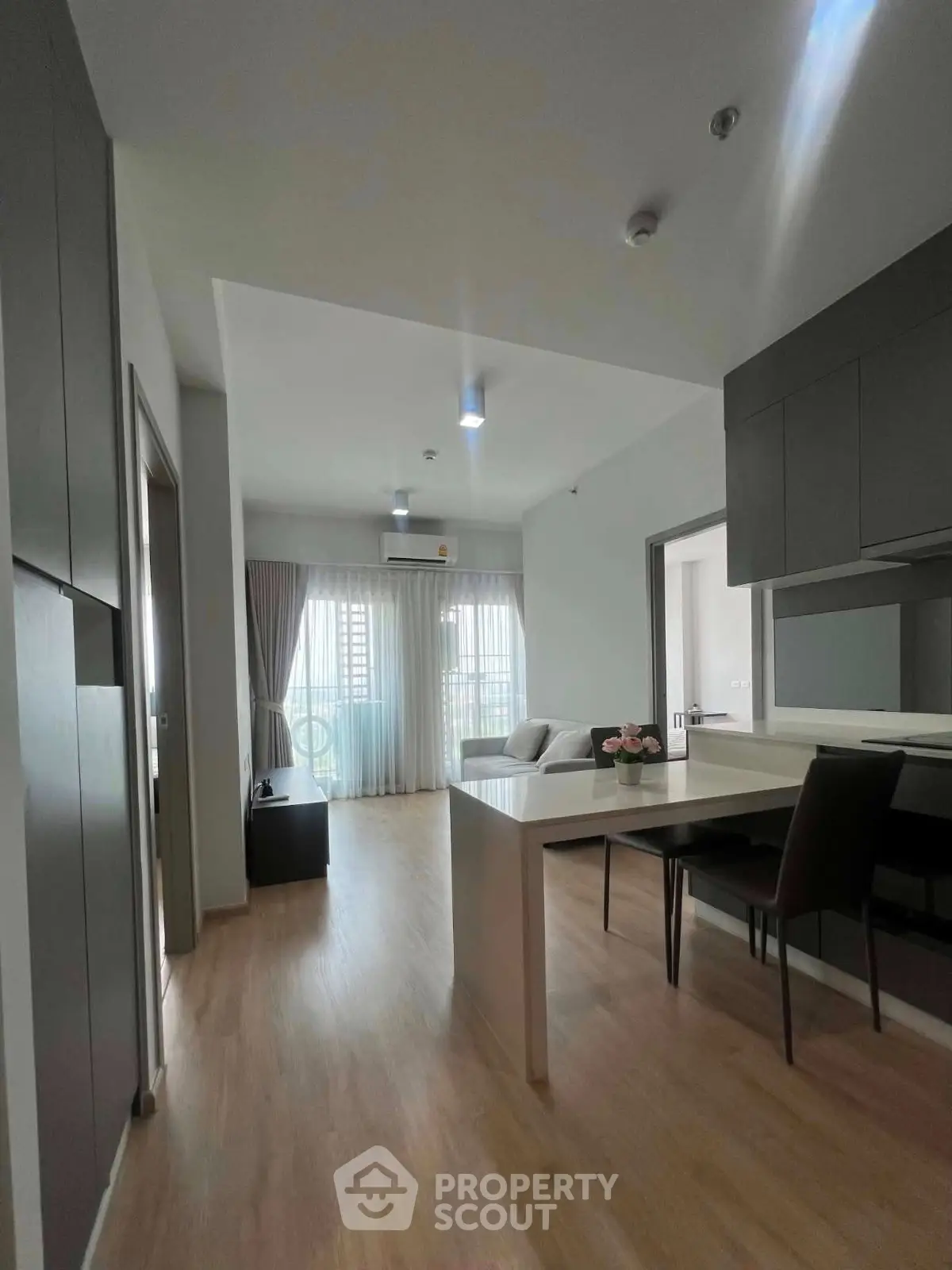 Modern open-plan living room with dining area and natural light