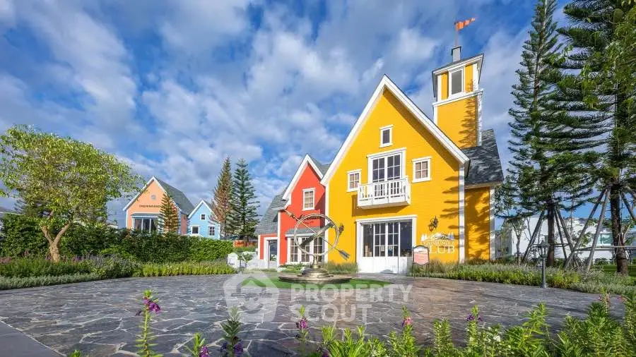 Charming colorful houses with lush landscaping and clear blue sky.