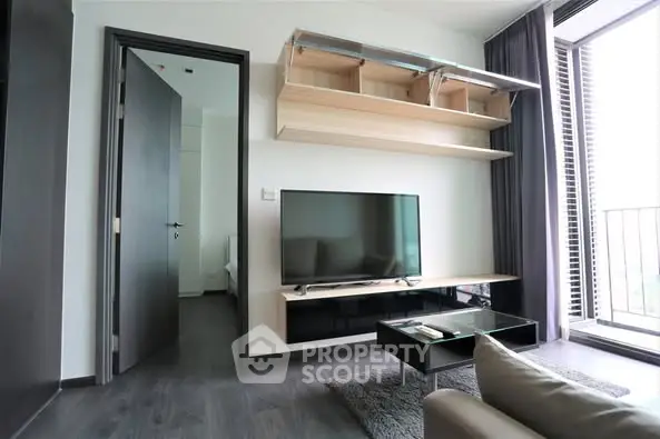 Modern living room with sleek TV setup and balcony view