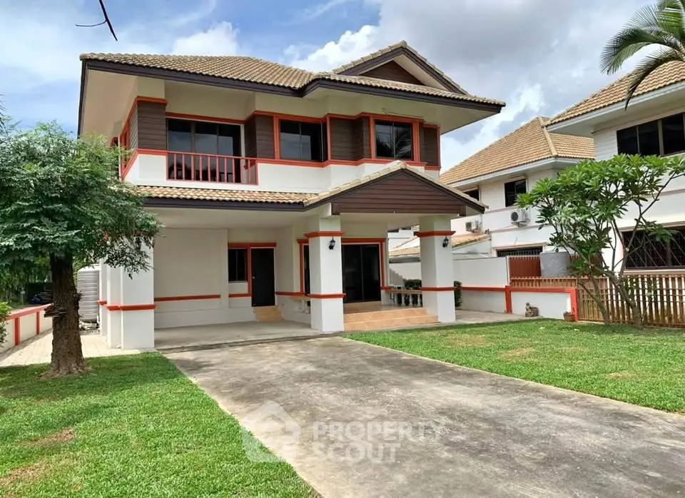 Charming two-story house with spacious driveway and lush green lawn in a serene neighborhood.