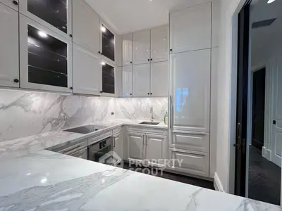 Luxurious modern kitchen with marble countertops and sleek cabinetry