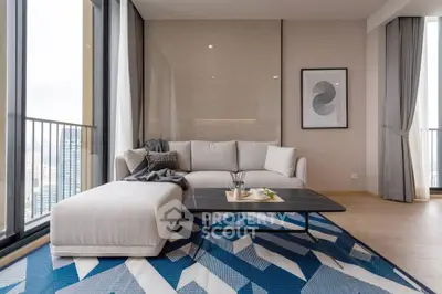 Modern living room with stylish sofa, geometric rug, and city view balcony.