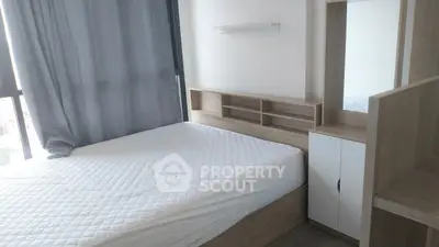 Modern bedroom with large window and stylish wooden furniture