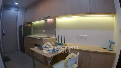 Modern compact kitchen with sleek cabinetry and dining setup