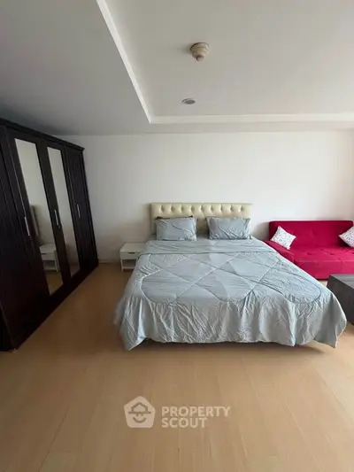 Spacious bedroom with modern furnishings and cozy ambiance