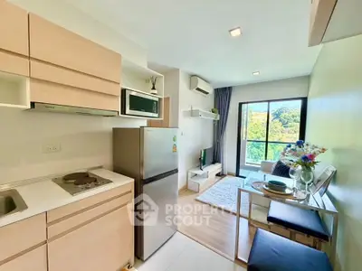 Modern open-plan kitchen and living room with balcony view in stylish apartment