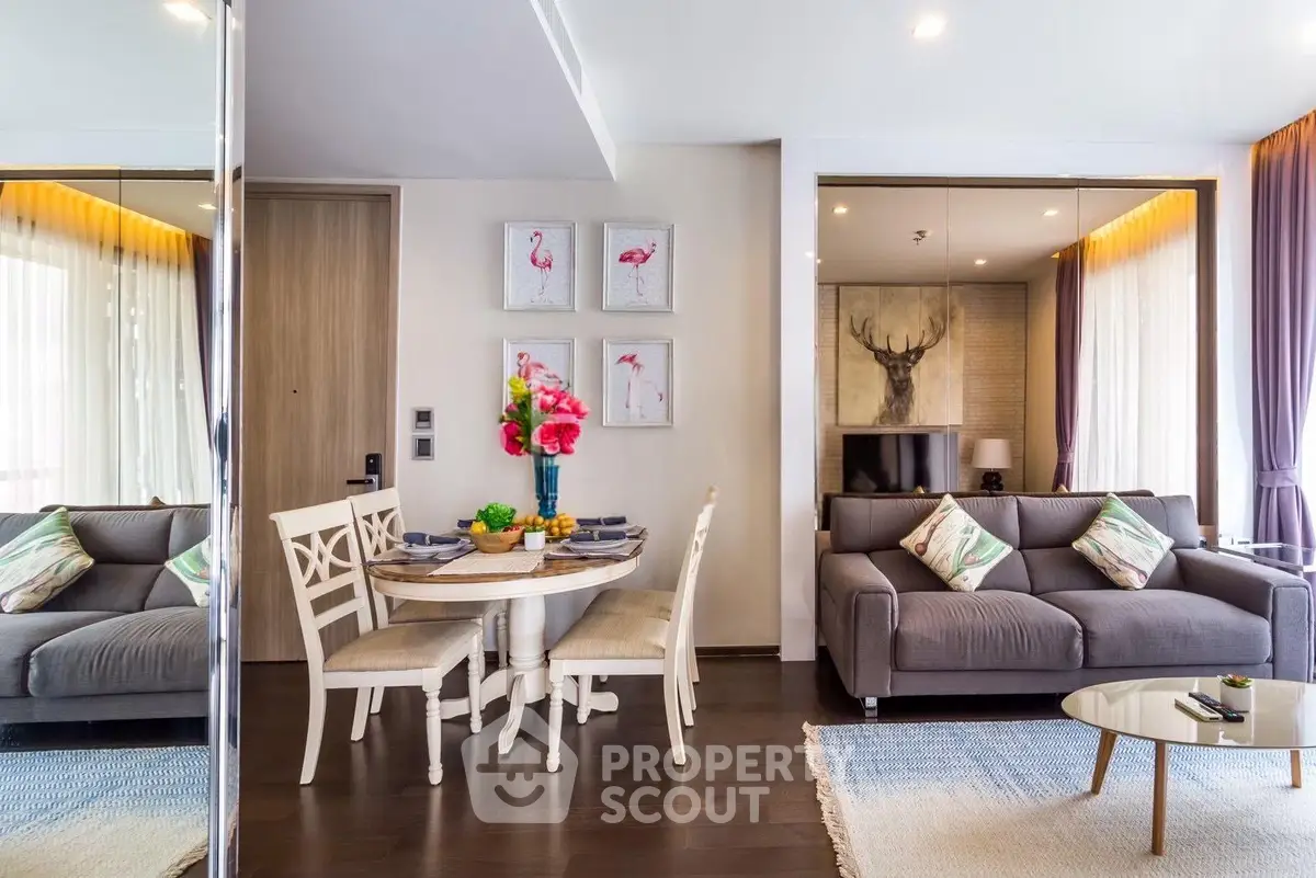 Modern living room with stylish decor, featuring a cozy sofa, dining table, and elegant wall art.