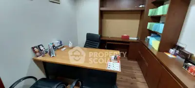 Modern office space with wooden desk and shelving, ideal for productivity and organization.