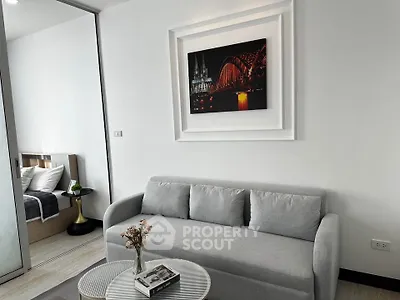 Modern living room with gray sofa and stylish decor in a contemporary apartment.