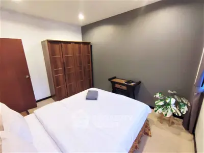 Cozy bedroom with elegant wooden wardrobe and stylish decor