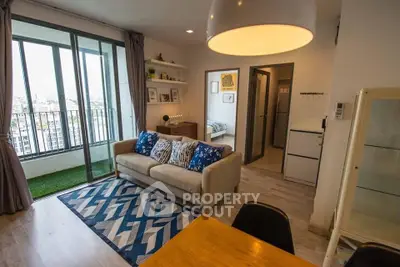 Modern living room with stylish decor and balcony view in a cozy apartment.