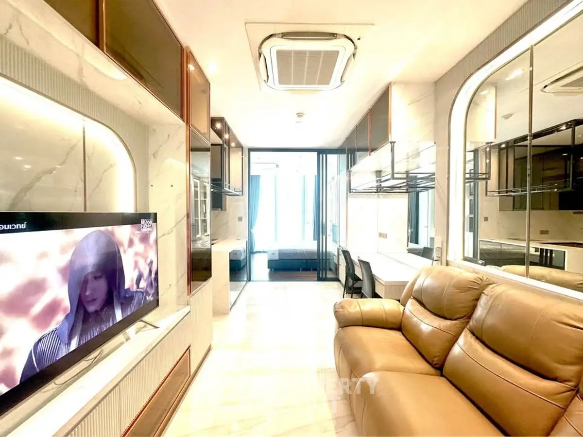 Luxurious modern living room with leather sofa and large TV, featuring elegant marble accents.