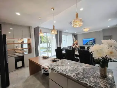 Luxurious open-plan kitchen and living room with elegant decor and modern lighting