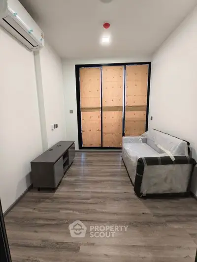Modern living room with sleek flooring and minimalistic furniture in a contemporary apartment.