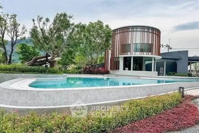 Luxurious modern home with stunning pool and lush garden landscape.
