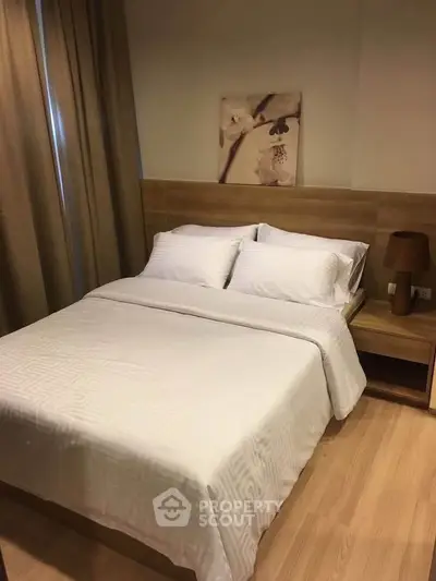 Cozy bedroom with modern decor and wooden flooring, perfect for relaxation.