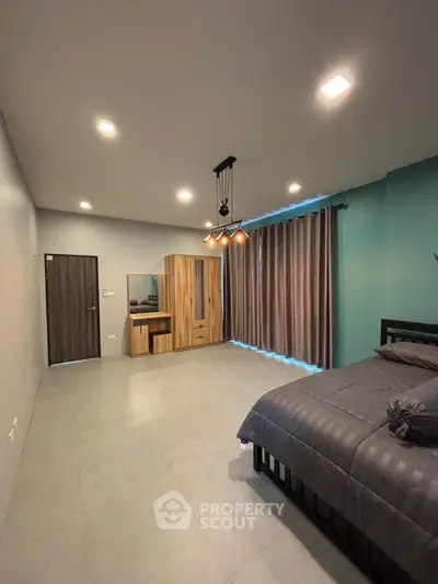 Spacious modern bedroom with stylish lighting and large wardrobe